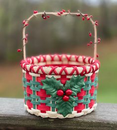 a red and green basket sitting on top of a wooden table