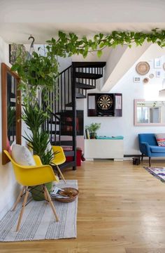 a living room filled with furniture and plants