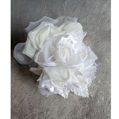 a white flower sitting on top of a wooden floor