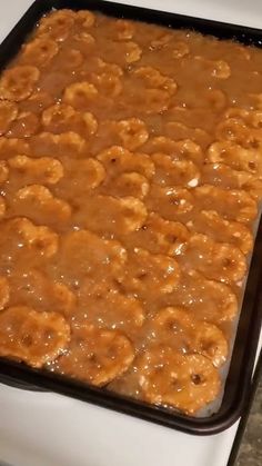 a pan filled with food sitting on top of a stove