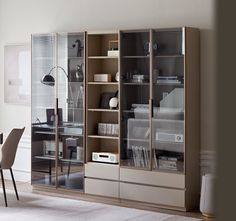 a room with a desk, chair and bookcase in it's center area