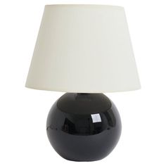 a black table lamp with a white shade on the top and bottom part of it