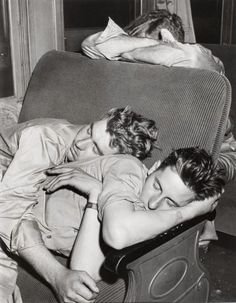 black and white photograph of two people laying on a couch