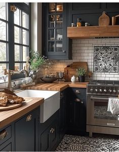 a kitchen with black cabinets and white tile backsplash, wood counter tops, and stainless steel appliances