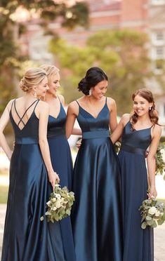 the bridesmaids are all dressed in dark blue dresses