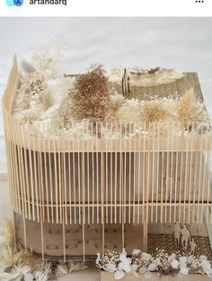 a birdcage filled with lots of stuff sitting on top of a table