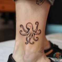 an octopus tattoo on the ankle