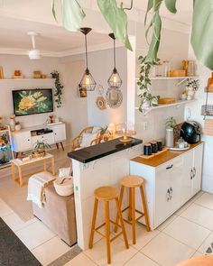 a kitchen filled with lots of counter space and wooden stools next to an island