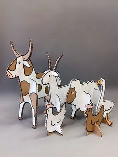 three wooden animals standing next to each other on a gray surface with one animal holding the other's hand