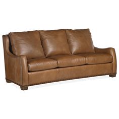 a brown leather couch sitting on top of a white floor