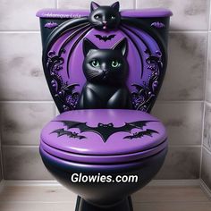 a black cat sitting on top of a purple toilet seat with bats painted on it