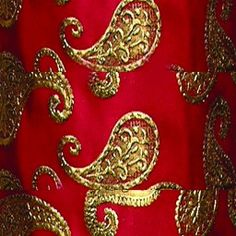 red and gold brocaded fabric with golden paisley design on it's side