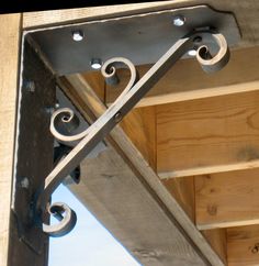 the corner of a wooden structure with metal brackets