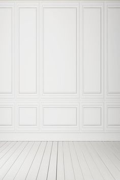 an empty room with white walls and wooden floors