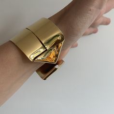 A lighter cuff on the repertoire. I have created this piece out of a single sheet of metal. It is completely formed and can be worn showing the ends on the front or the wide strip on the front. ~1.5 wide   ~fabricated out of a single brass sheet and finished in 14k nickel free gold plating  Bracelet is light and can be adjusted to fit the wrist. Slip on gently due to the ends but adjust by softly squeezing to fit around your wrist a little less loosley. Modern Metal Cuff Bangle, Gold Modern Cuff Bracelet For Formal Occasions, Modern Gold Cuff Bracelet For Formal Occasions, Gold Cuff Jewelry With Polished Finish, Yellow Gold Cuff Bracelet For Party, Party Yellow Gold Cuff Bracelet, Modern Metal Cuff Bracelet, Formal Polished Brass Cuff Bracelet, Gold Polished Cuff Bracelet