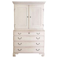 an old white dresser with drawers and doors on it's front legs, against a white background