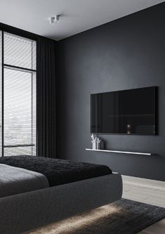 a bedroom with black walls and white trimmings has a flat screen tv on the wall