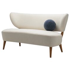 a white couch with a blue ball on it's back end and legs, against a white background