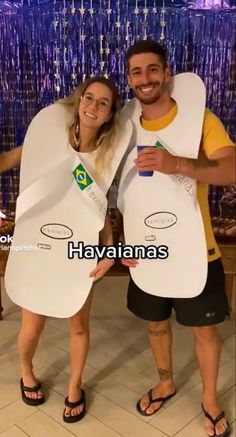 a man and woman standing next to each other holding up giant paper plates in front of them