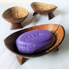 two wooden bowls with purple soap in them