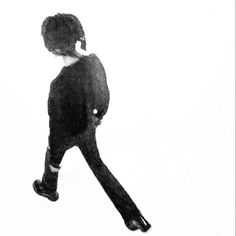 a black and white photo of a person walking with their back turned to the camera