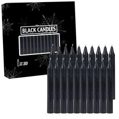 black candles are lined up in front of a box with snowflakes on it