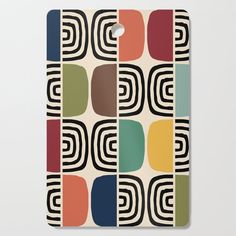 a cutting board with multicolored squares on the front and back of it,