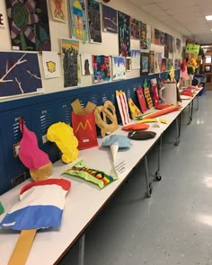 there are many different items on the table in this classroom setting, including t - shirts and hats