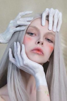 a woman with white hands on her head and the words models to draw over her face