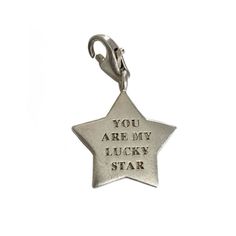 a silver star charm that says you are my lucky star