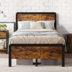 a bed with wooden headboard and foot board next to two nightstands on carpeted floor