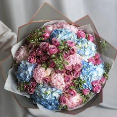 a bouquet of pink, blue and white flowers