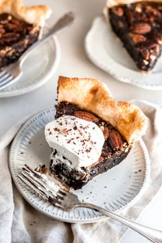 a slice of chocolate pie on a plate with a fork next to the rest of the pie