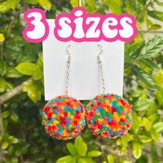 * Another twist on out popular rainbow earrings. These poms feature our red, hot pink, orange, yellow, green, and tropical blue yarn.  🌈✨ *Made to Order* Processing time for pom pom earrings is 3-5 days. Available with star chain or regular chain. Your choice of gold or silver chain. Chain Length  * Chain for small and large pom earrings is approx 1.5 inches long.  * Chain for mini  pom earrings is approx 1 inches long. If you would like Star chain for the mini poms, please note that the 1 inch length only includes 2 stars on the chain. *If you would like a shorter chain, please leave a note in the personalization box.  Pom Sizes *Mini poms approx. 1.25 inches in diameter  *Small poms approx. 1.5 inches in diameter  *Large poms approx. 2 inches in diameter Silver and gold plated earring h Hypoallergenic Multicolor Earrings For Parties, Playful Rainbow Earrings With Ear Wire, Trendy Multicolor Dangle Plug Earrings, Trendy Multicolor Drop Clip-on Earrings, Fun Rainbow Earrings, Trendy Multicolor Drop Plug Earrings, Trendy Multicolor Hypoallergenic Earrings, Playful Multicolor Pierced Earrings, Playful Multicolor Ear Wire Earrings