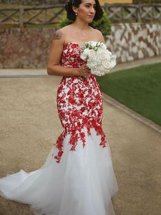 a woman in a red and white dress holding a bouquet