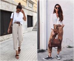 two women in white shirts and brown pants are walking down the street, one is carrying a purse