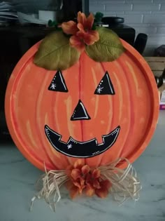 a pumpkin shaped plate sitting on top of a counter