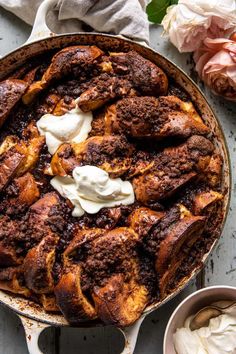 a chocolate dessert in a pan with whipped cream on top