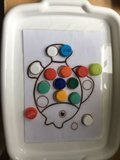 a child's artwork on the wall with buttons