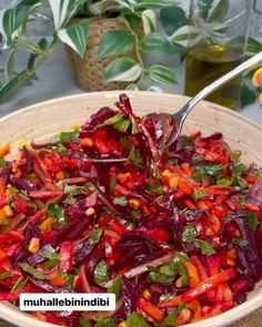 a bowl filled with lots of vegetables on top of a table