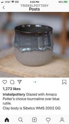 a black and white bowl sitting on top of a wooden table