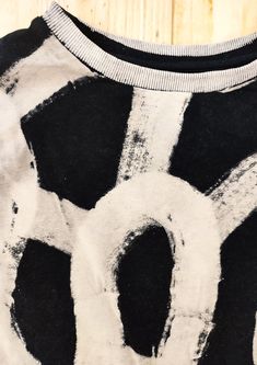 a black and white t - shirt with the letter o on it