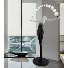 a black and white sculpture in front of a window