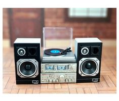 two stereo speakers and a record player on a table