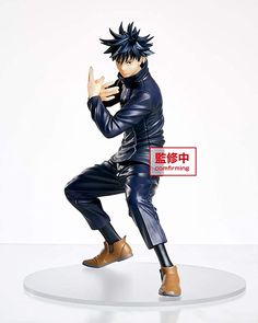 an action figure is posed on top of a round base with his hands in the air