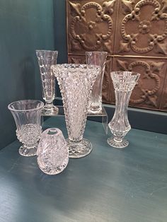 an assortment of glass vases on a table