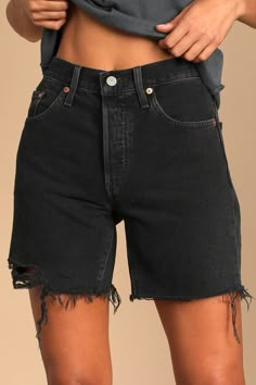 The Levi's 501 Mid Thigh Washed Black Cutoff Denim Shorts offer the classic fit of your 501's with a little added length! These adventure-ready long denim shorts are composed of a medium-weight non-stretch denim (in Levi's Lunar Black wash) and feature a high-waist, longer, mid-thigh cut, and frayed raw hems to finish the look. Belt loops, five-pocket cut, branded top button, and hidden button fly. Leather patch and red logo tag at back. Fit: This garment fits true to size. Length: Mid-thigh. Si Mid Thigh Jean Shorts, Jean Shorts Black, Long Denim Shorts, Mid Thigh Shorts, Diy Summer, Short Denim, Denim Cutoff Shorts, Denim Cutoffs, Levi’s 501