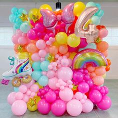 a bunch of balloons that are in the shape of letters and numbers on a table