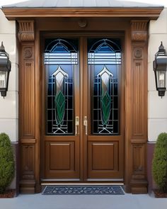 two stained glass doors in front of a house