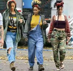 three women walking down the street in overalls and hats with dreadlocks on